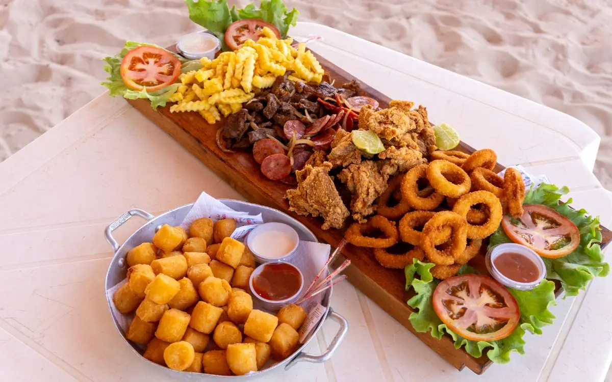 Petiscos e porção do espaço de alimentação da Praia da Figueira, servidos à beira da praia